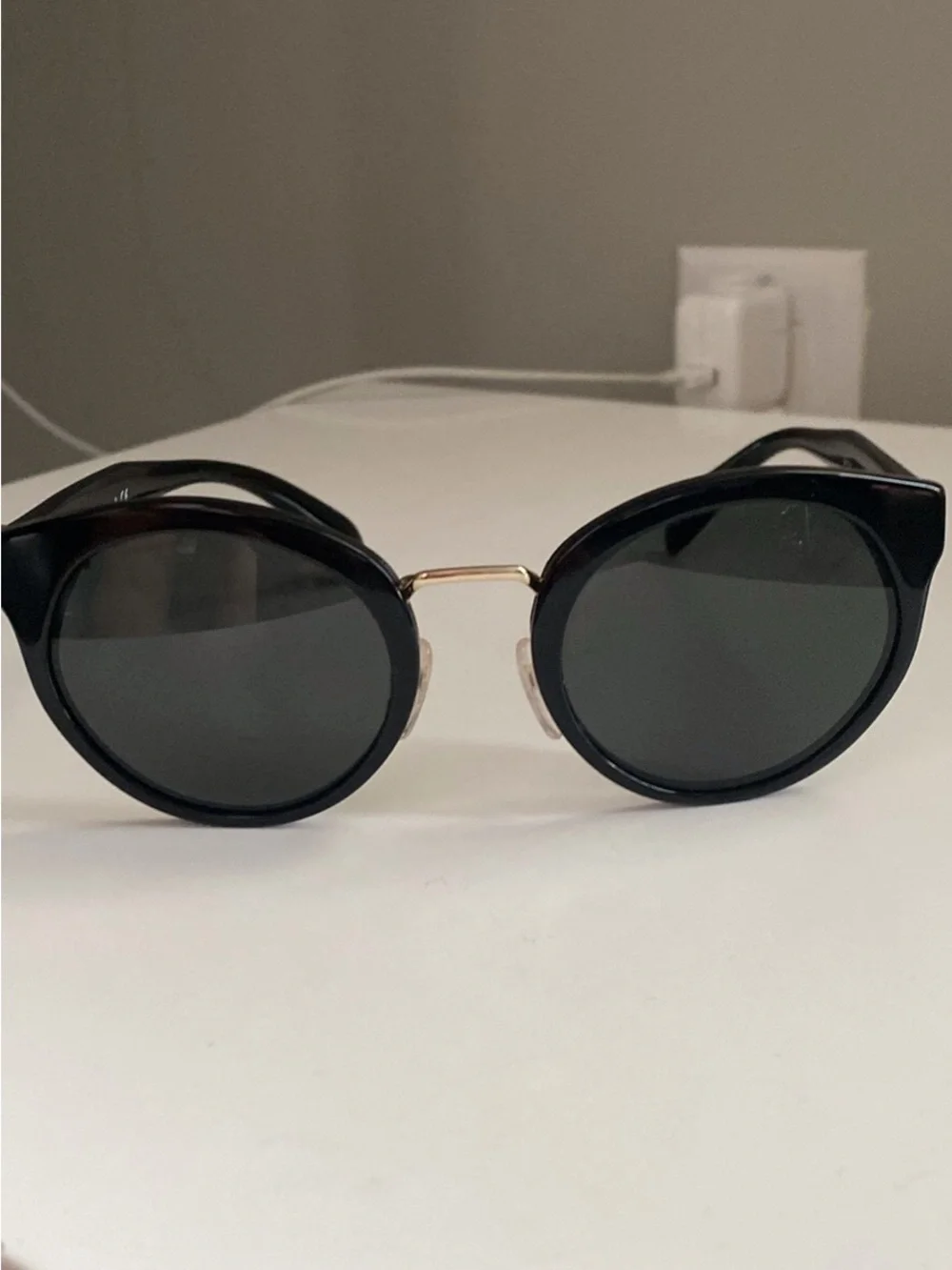 Prada Black Round Sunglasses with Gold Detailing